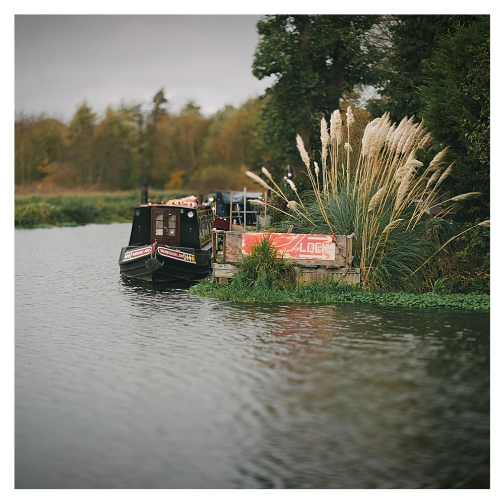Barge parked by rivers edge 