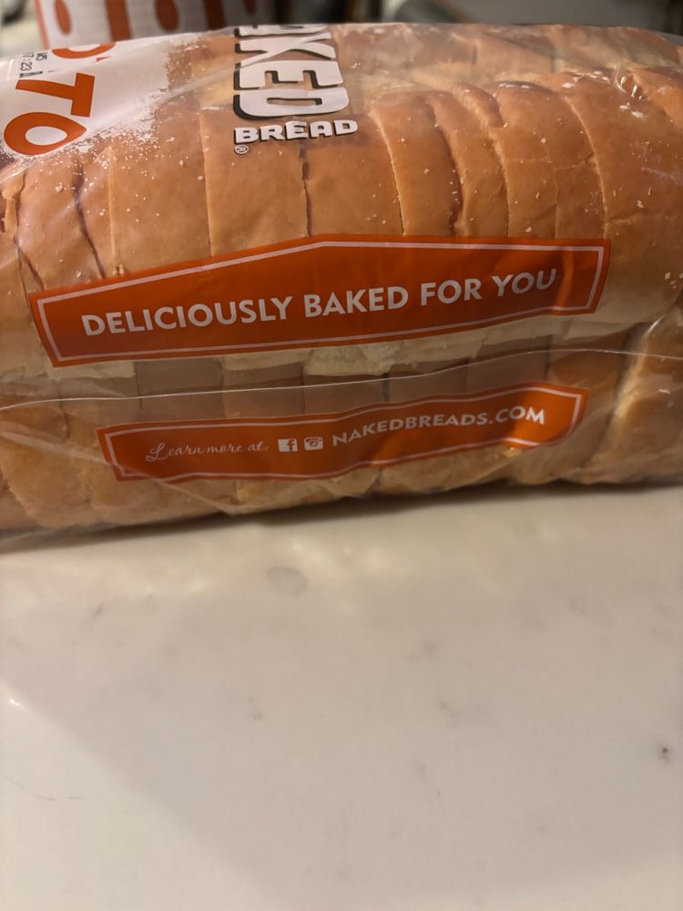 A loaf of bread with the words “DELICIOUSLY BAKED FOR YOU” printed on the bag.
