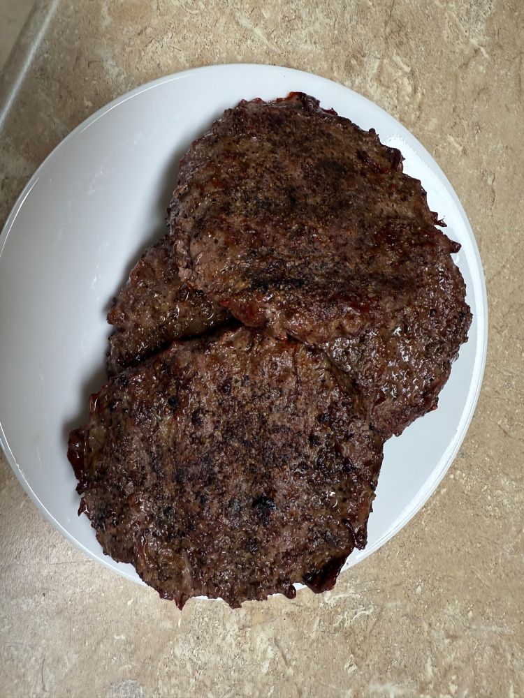 Burgers cooked medium well from the charcoal grill