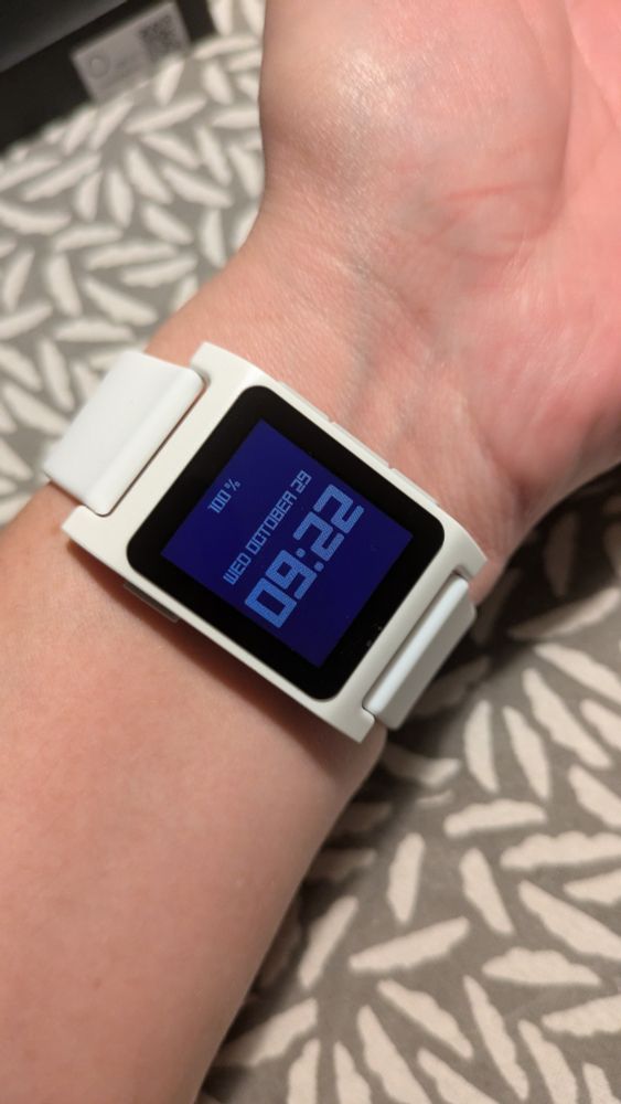 Watch shown on wrist. Backlight is on.
