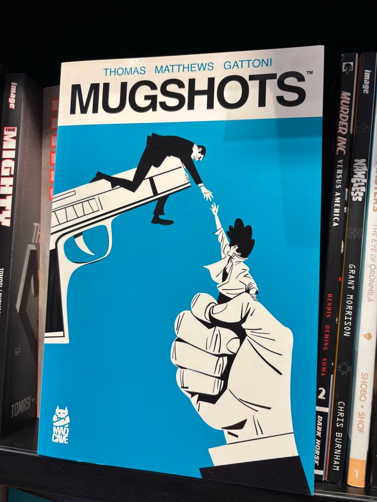 A copy of the Mugshots graphic novel on the Waterstones shelf.
