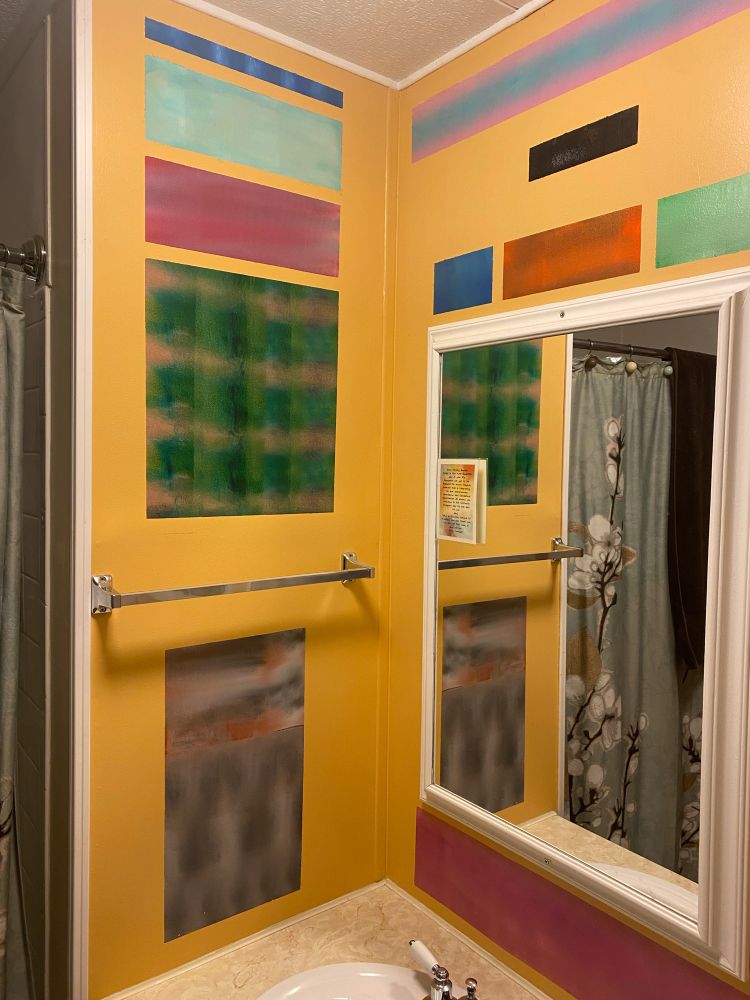 Bathroom walls painted with block shapes in multiple colors 
