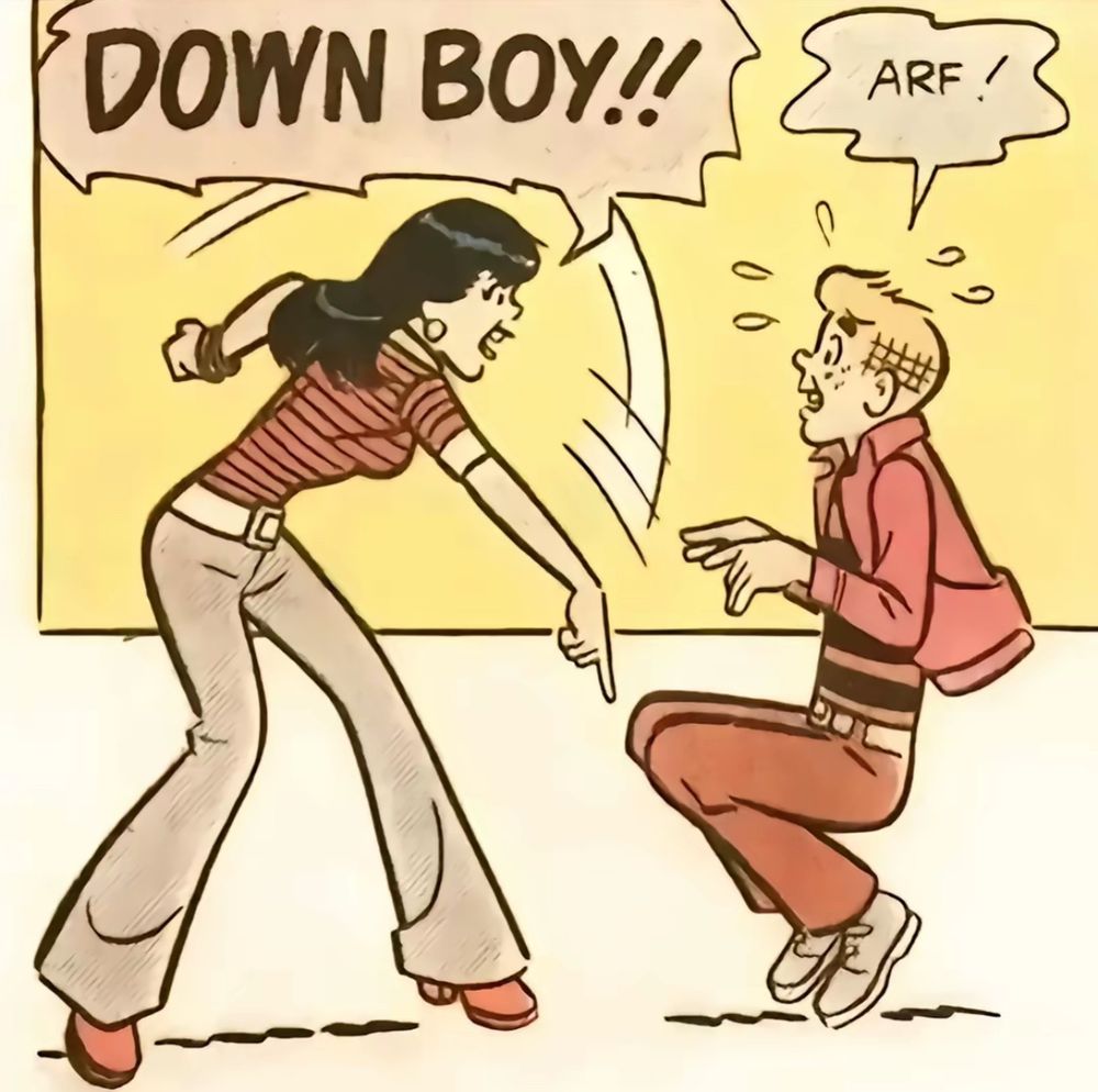 Archie comic panel of a black haired girl having her hand out pointing at floor yelling “DOWN BOY !!” while her blonde boyfriend is obeying by squatting on the floor with his arms out, sheepishly replying “aarf!” 