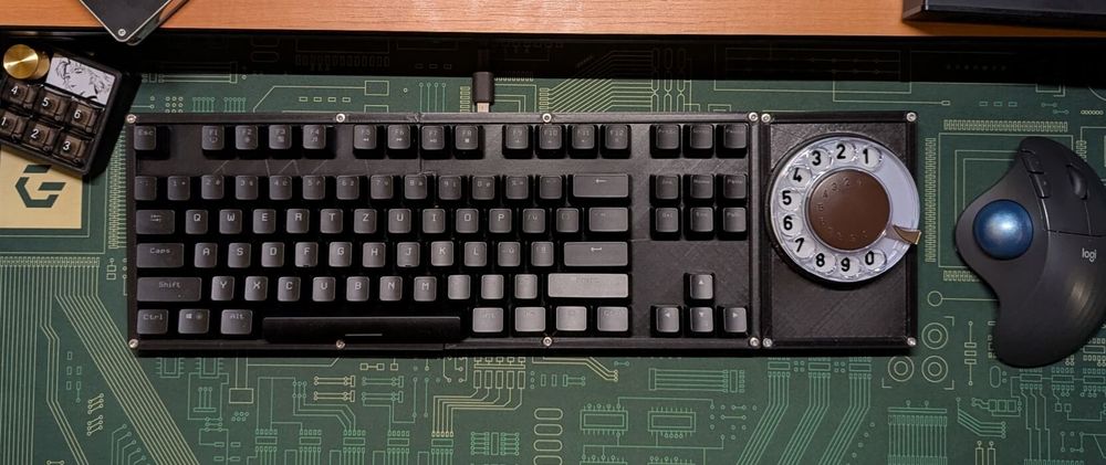 a mechanical keyboard that uses a rotary dial from an old phone as a numpad