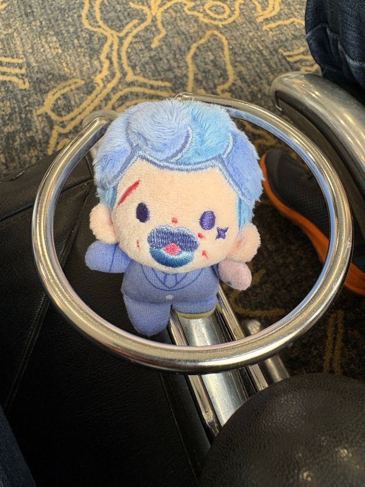 5 cm Izzy by rights in a cup holder of an airport chair. He’s really really little and very cute 
