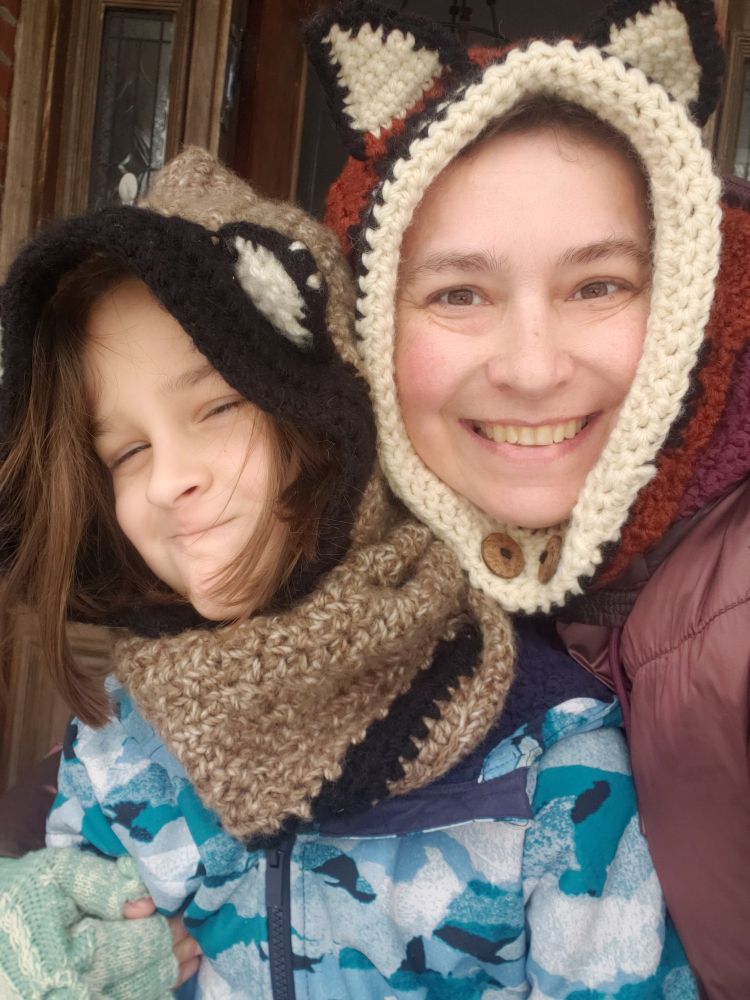 2 people wearing fox shaped hoods 