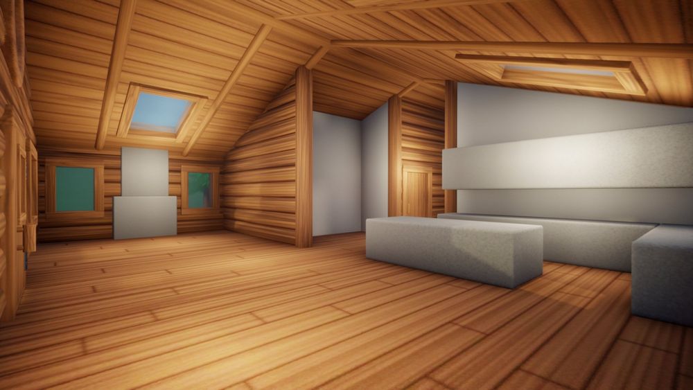 A view of a log cabin interior that shows a large open room with a kitchen and living room.