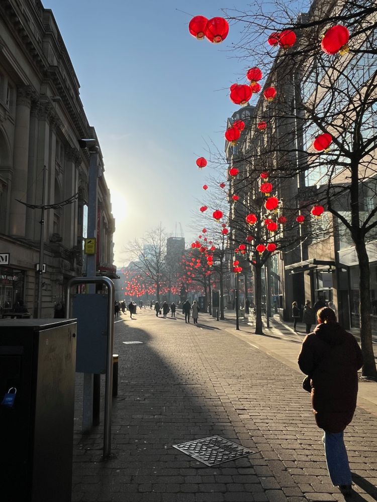 Chinese Lanterns in the trees on a sunny day in St Anne's Square Manchester.