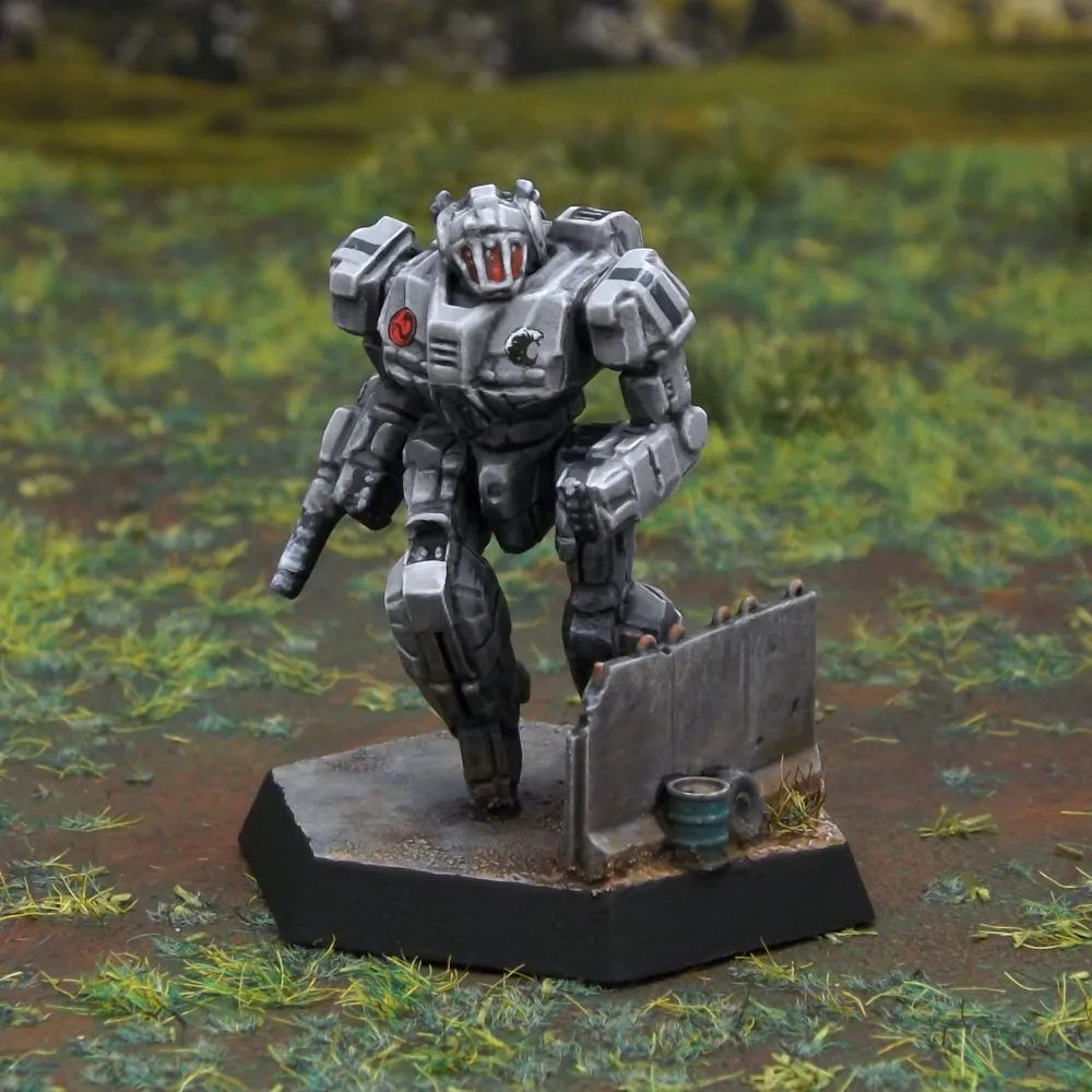 A painted miniature of a Wasp 'Mech.  It is light ash gray, and the cockpit glass is dark red.  It is posed as if dashing.  Some of its legs are obscured from view by a knee-high gray concrete wall.  An oil drum and tire are next to the wall.  The dragon emblem of the Draconis Combine is on its right torso.  The emblem of the Genyosha, a black wave, is on the left torso.  Thin black stripes decorate its shoulders.  The miniature is photographed on grassy terrain.
