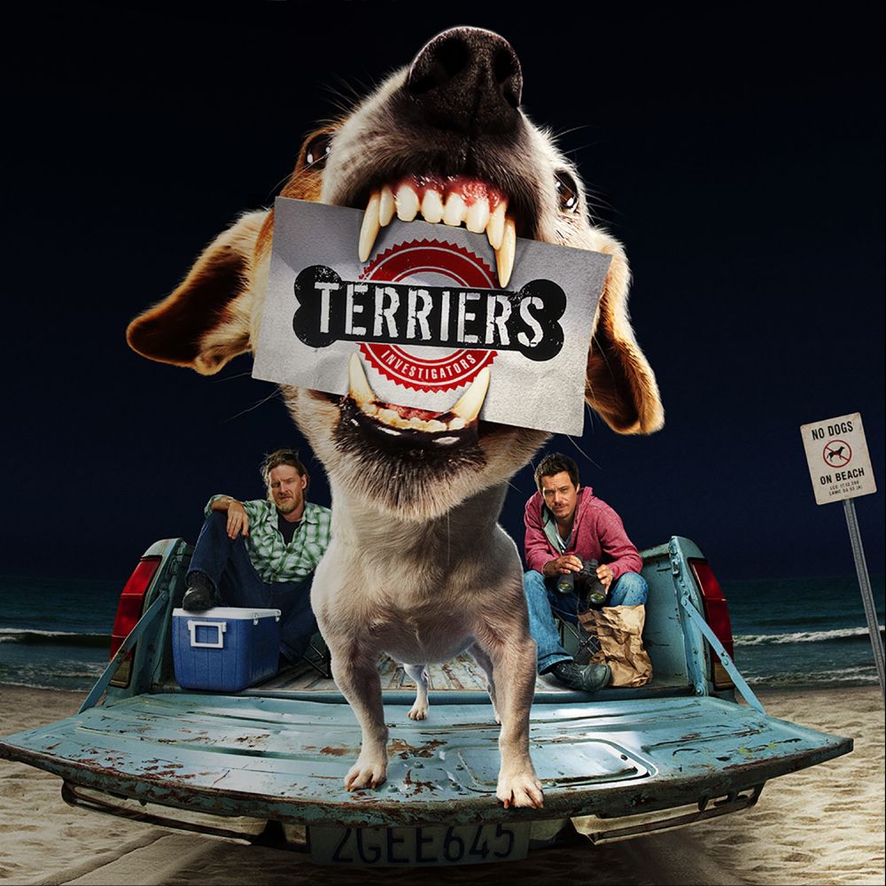Promo for FX's Terriers, a little dog holding a card saying Terriers in his jaws while standing on the tailgate of a truck. Two men sit in the truck bed, one with a pair of binoculars and the other with a cooler. A sign off to the right days 