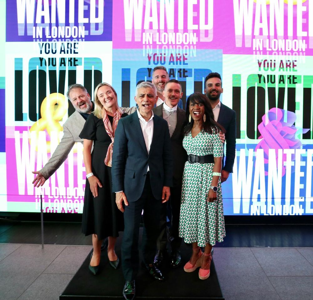Mayor Sadiq Khan and deputy mayors stand in front of sign reading 'In London you are loved and wanted'