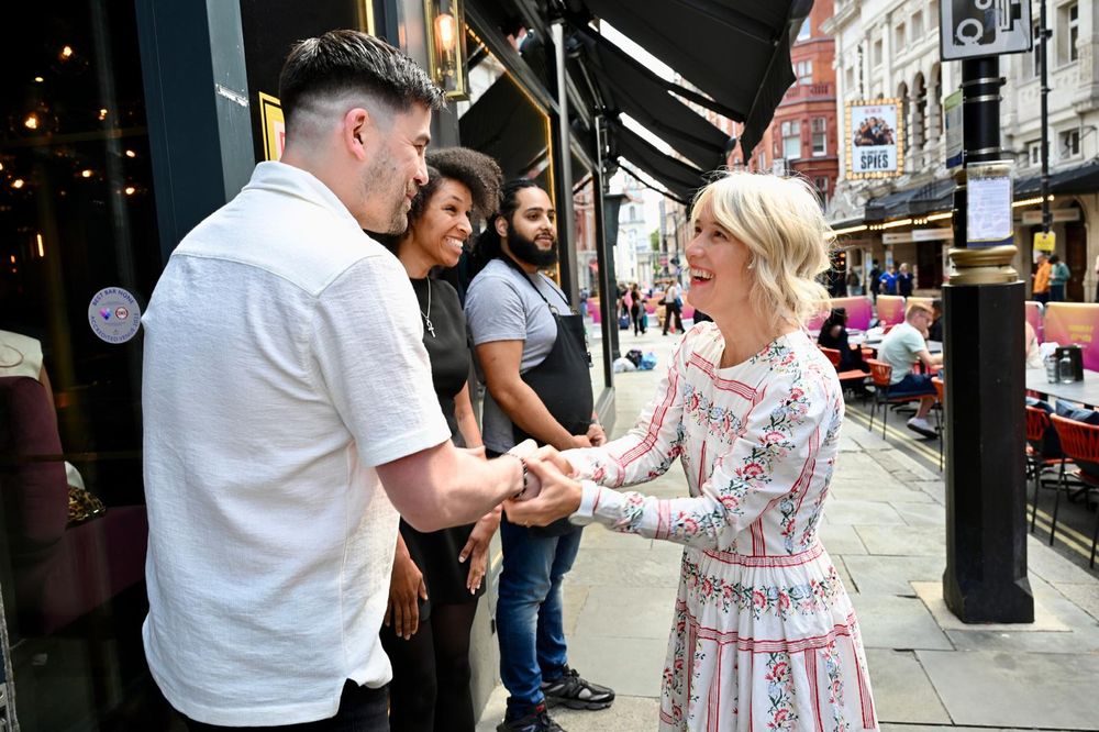 Justine Simons OBE - Deputy Mayor for Culture and Creative Industries, shaking hands with business owners and staff, celebrating the start of Summer Streets in the West End.