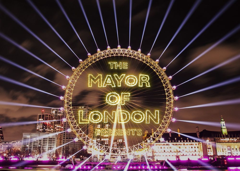 The London Eye featuring the wording ‘The Mayor of London presents’, lights are projected from around the wheel.