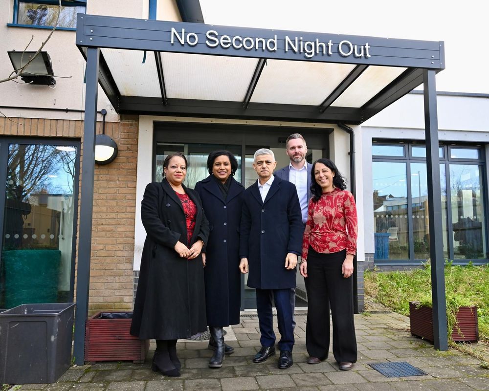 Photo of Mayor of London Sadiq Khan, Deputy Mayor for housing, Tom Copley and guests standing outside St Mungo’s No Second Night Out Assessment centre. 