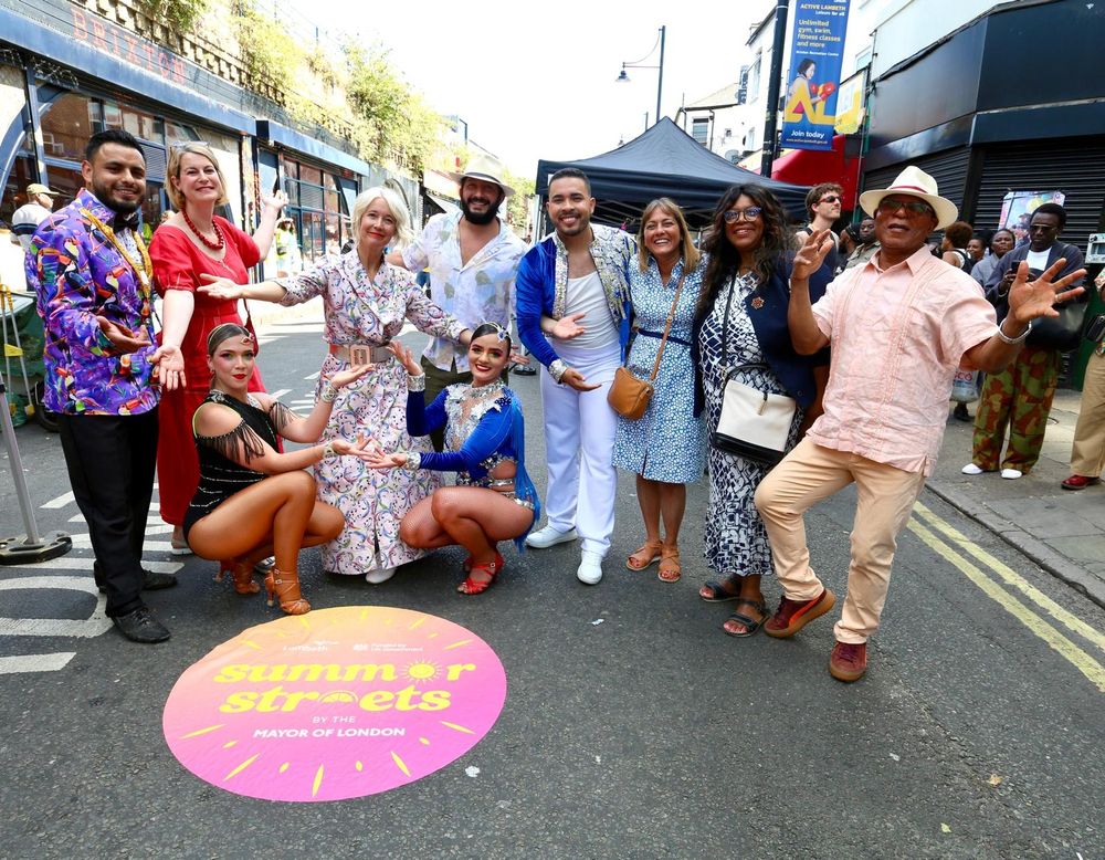 Deputy Mayor Justine Simons and others pose in front of the Summer Streets sign on the road