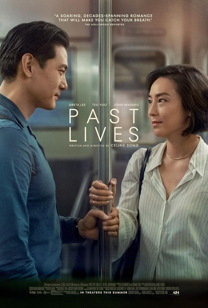 Poster for Past Lives. A man and woman on a subway train look at each other, both smiling slightly, both holding onto the same handle, their hands just inches apart.

The title sits just in the space between them.