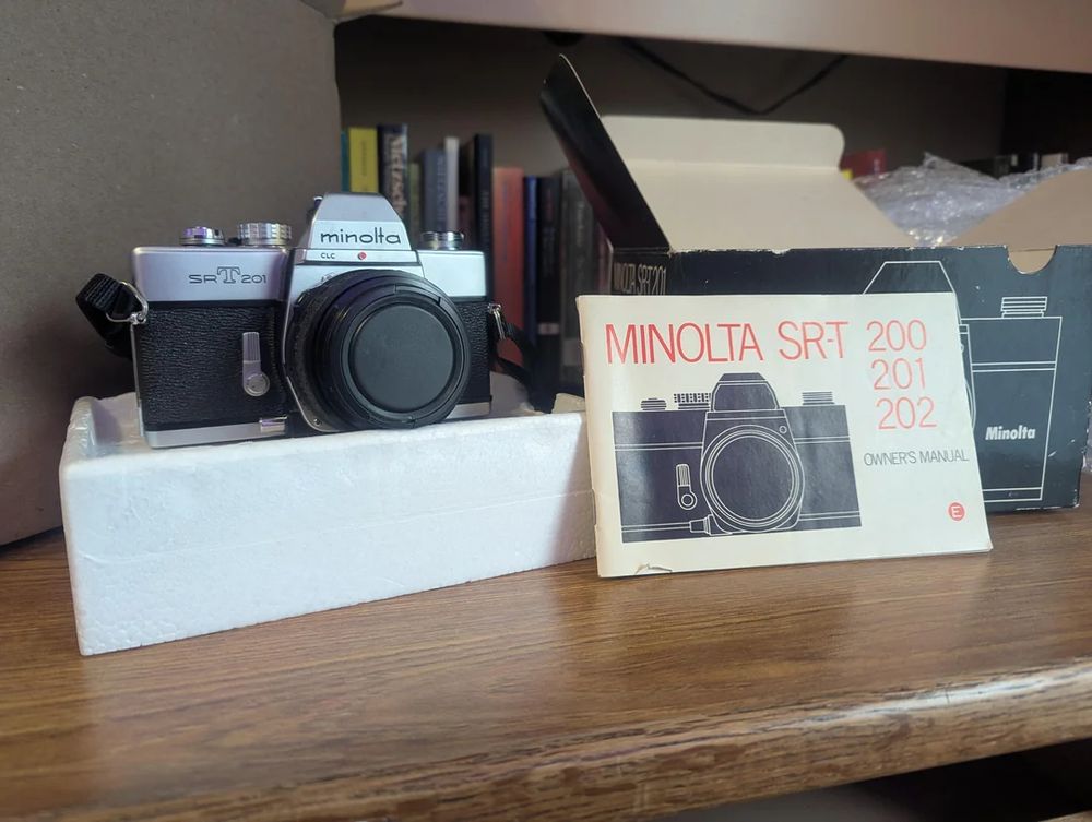 the camera next to its original box and manual
