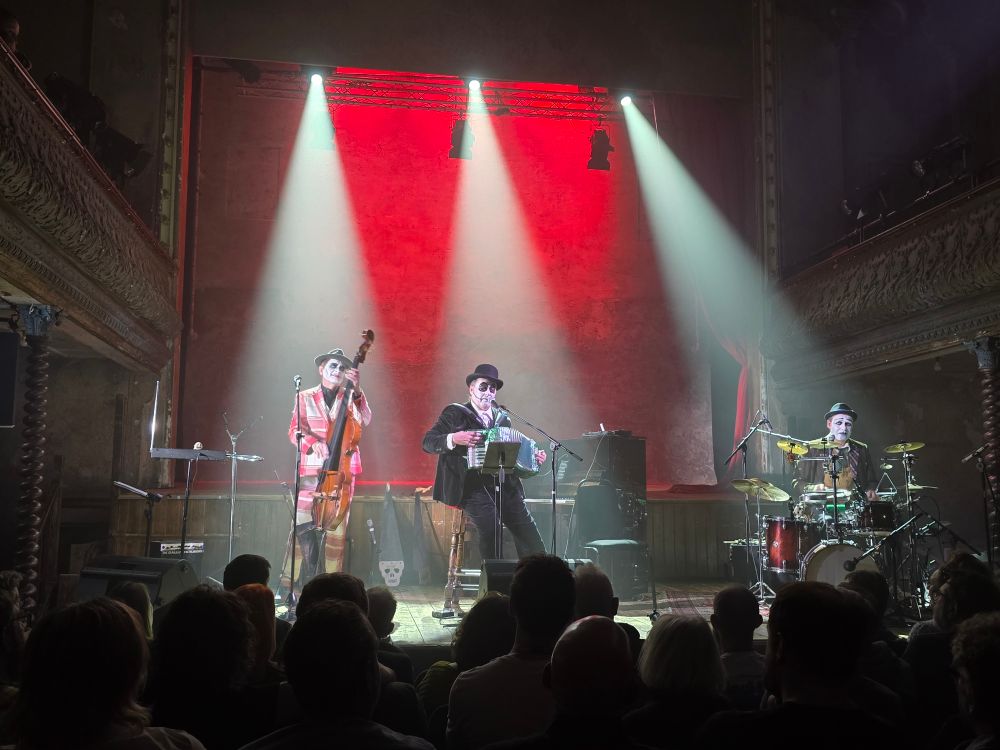 Tiger Lilies bathed in red and white light on stage