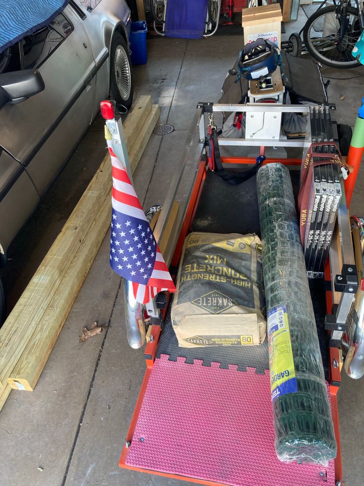 Another load for the fence project. 80 pounds of concrete mix and a roll of temp fencing on the heavy lift trailer. The 4x4s to the left came in on an earlier cargo bike trip. 