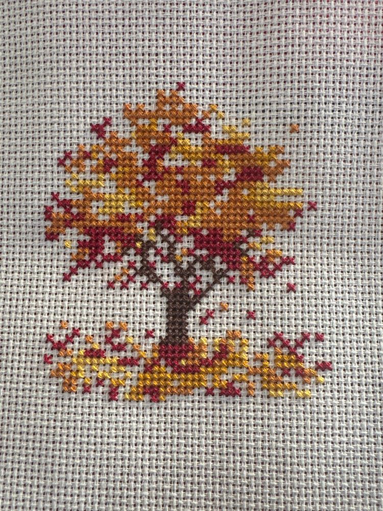 Cross stitch pattern of a leaves turning color in the fall

Orange, red, yellow leaves with a brown tree trunk