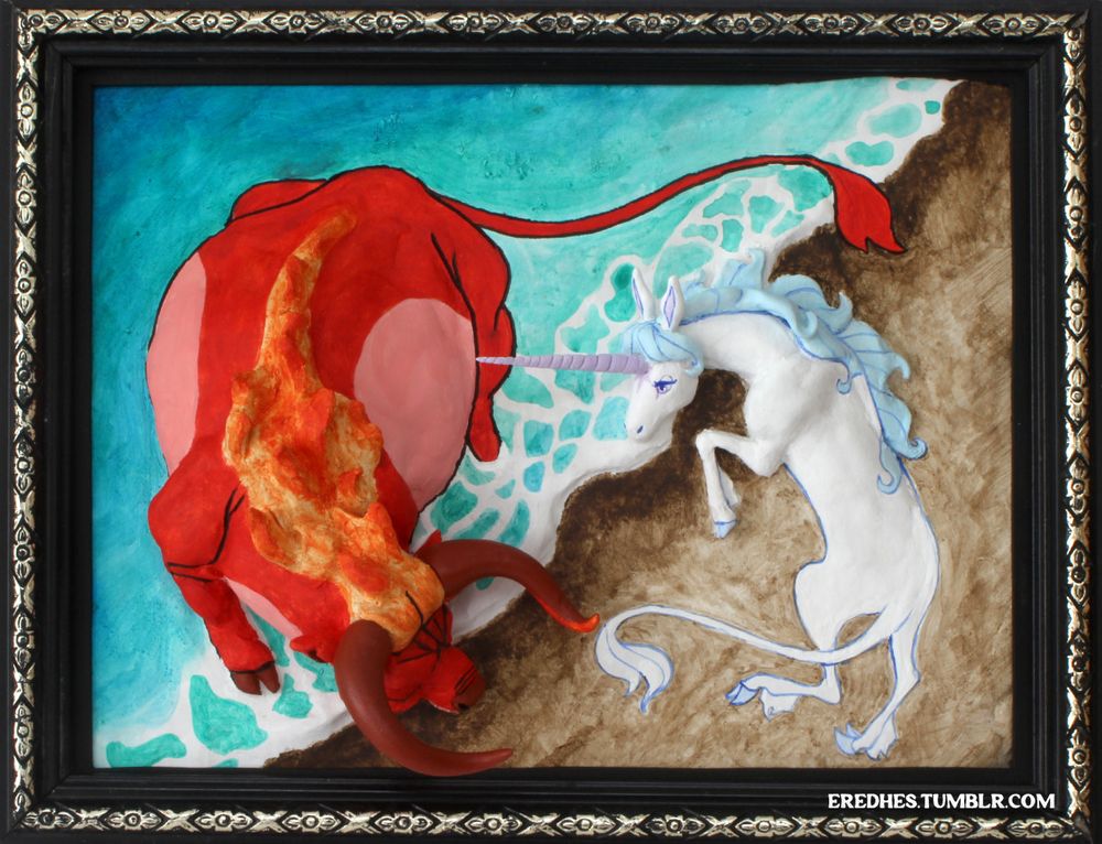 Photo of a framed relief sculpture based on the film The Last Unicorn. It shows the final fight between the Unicorn and the Red Bull at the edge of the sea, with the Bull in the sea and the Unicorn on the sand. They are arranged in a circular form with the Bull on the left facing downwards turned to the right and the Unicorn vice versa. Their heads are three dimensional. It is in a black frame with a silver criss-cross pattern around the edge.