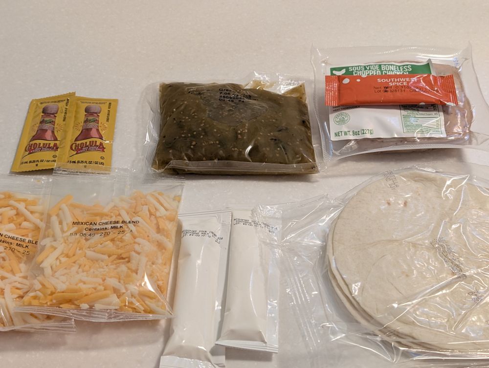 Ingredients for enchiladas: hot sauce, salsa Verde, spices, chicken, Mexican cheese blend, sour cream, and tortillas.