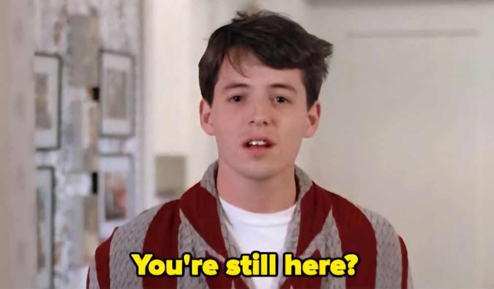 Ferris Bueller, from the shoulders up in a bathrobe with wide, muted red and grey stripes. He's looking straight at you, yes, you, with a look on his face as if to suggest he's wondering why you're still here. The caption shows him saying, 