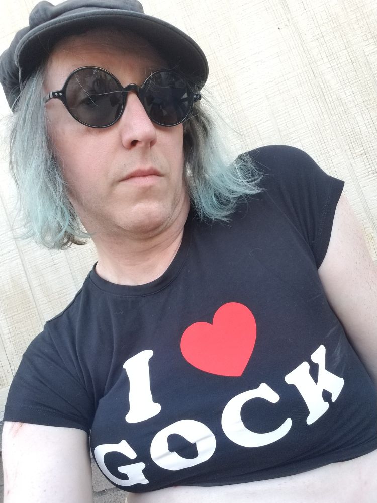 zara's wearing a black crop top that says "I love gock"