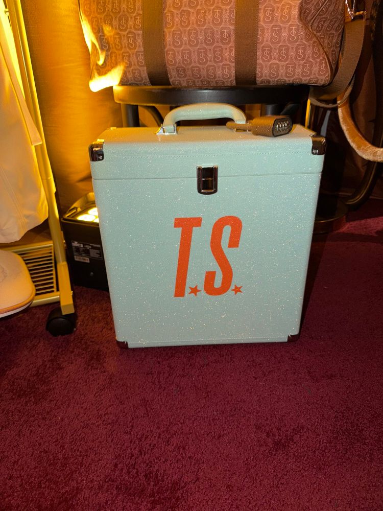 Mint Green Vinyl case with Orange letters “T.S.” Sparkly lock is on handle of case.