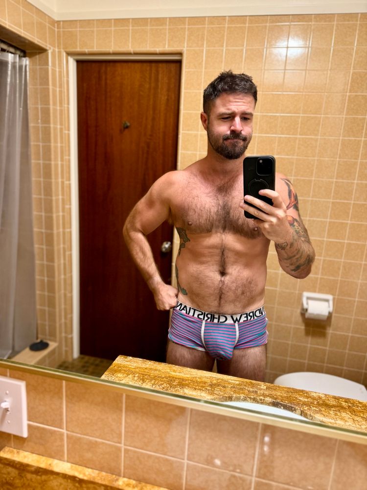 Me in my bathroom in pink and blue trunks