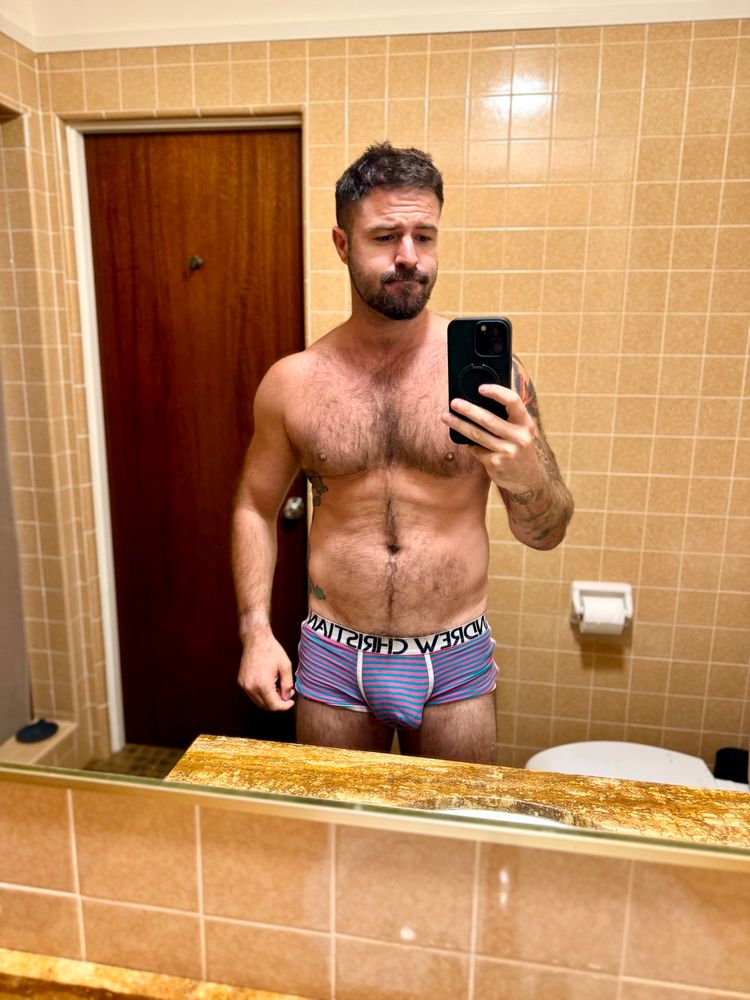 Me in my bathroom in pink and blue trunks