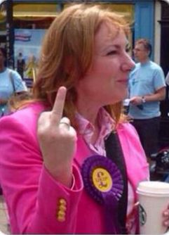 Janice Atkinson of Ukip dressed in a bright pink jacket, giving people the middle finger.