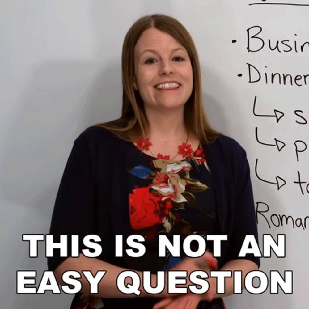 a woman stands in front of a white board with the words this is not an easy question