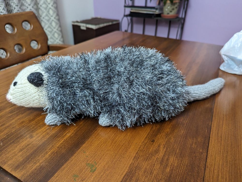 the stuffed knit opossum, side view