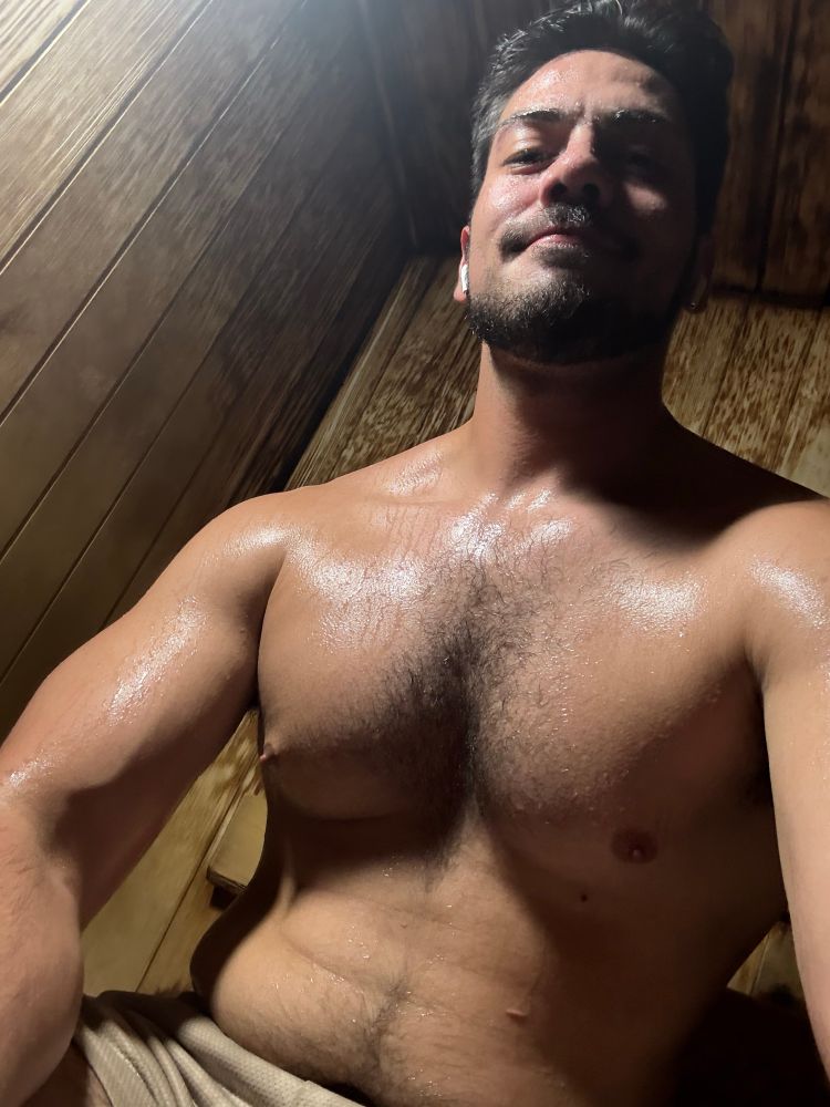Seismic sitting hunched over in a wood paneled sauna, sweaty