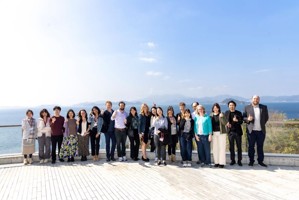 Conference participants pose in front of Victoria Harbour at the University of Chicago's Hong Kong campus.
