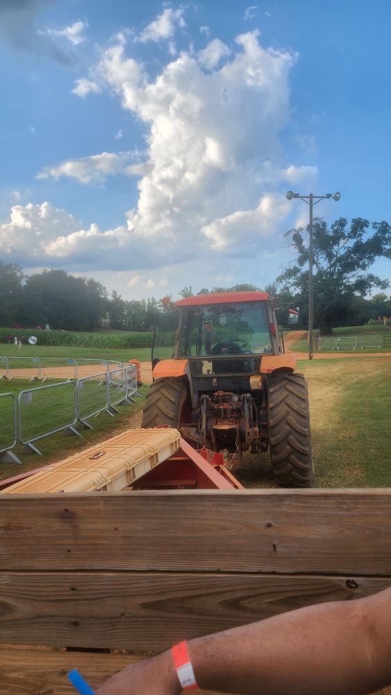 A tractor ride with grass and the sky in the background
