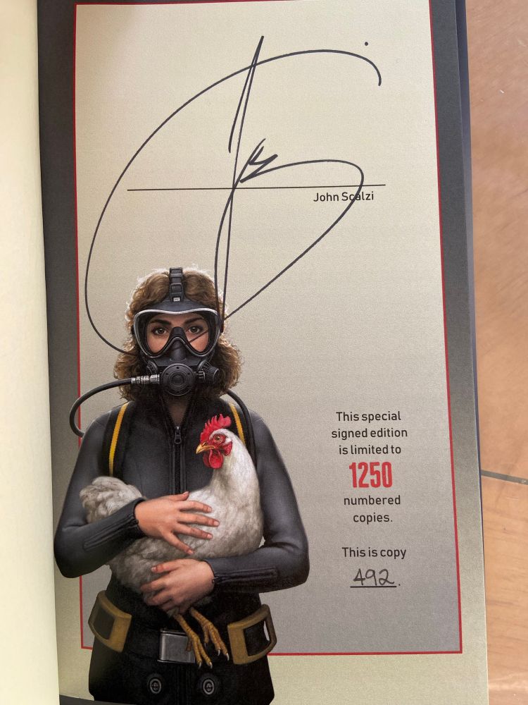 Inserted page signed by author, with picture of woman in scuba suit holding a chicken