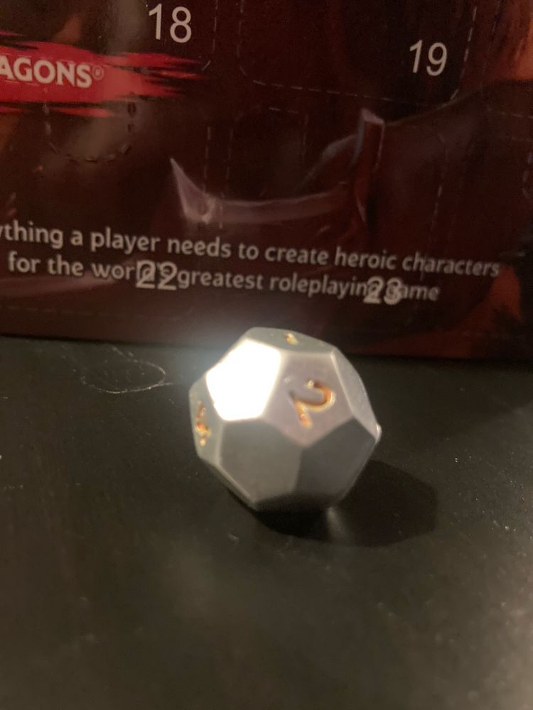 A D20 with lots of numbers missing from the sides of it. 