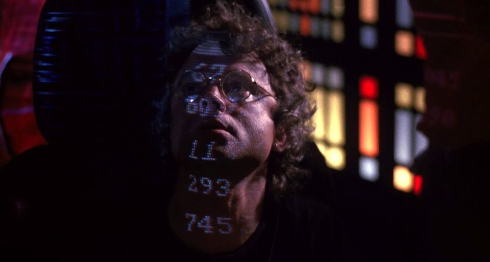 A screenshot of Brad Dourif in the movie, "Critters 4" (1992). He plays a spaceship engineer named "Al Bert."