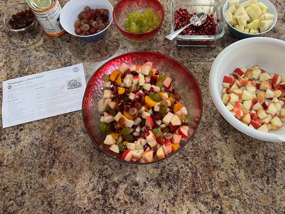 Bowl of fruit salad, surrounded by bowls of individual fruit salad ingredients. Not shown: fruit salad syrup.
