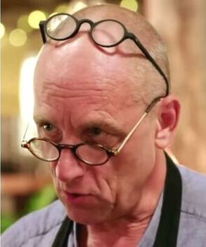Steve from the BBC show The Repair Shop wearing one pair of glasses low on his nose and other on top of his head