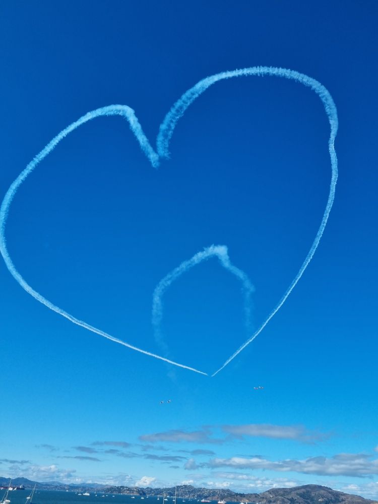 A smoke trail in a heart shape flown by the Canadian Royal Air Force display team