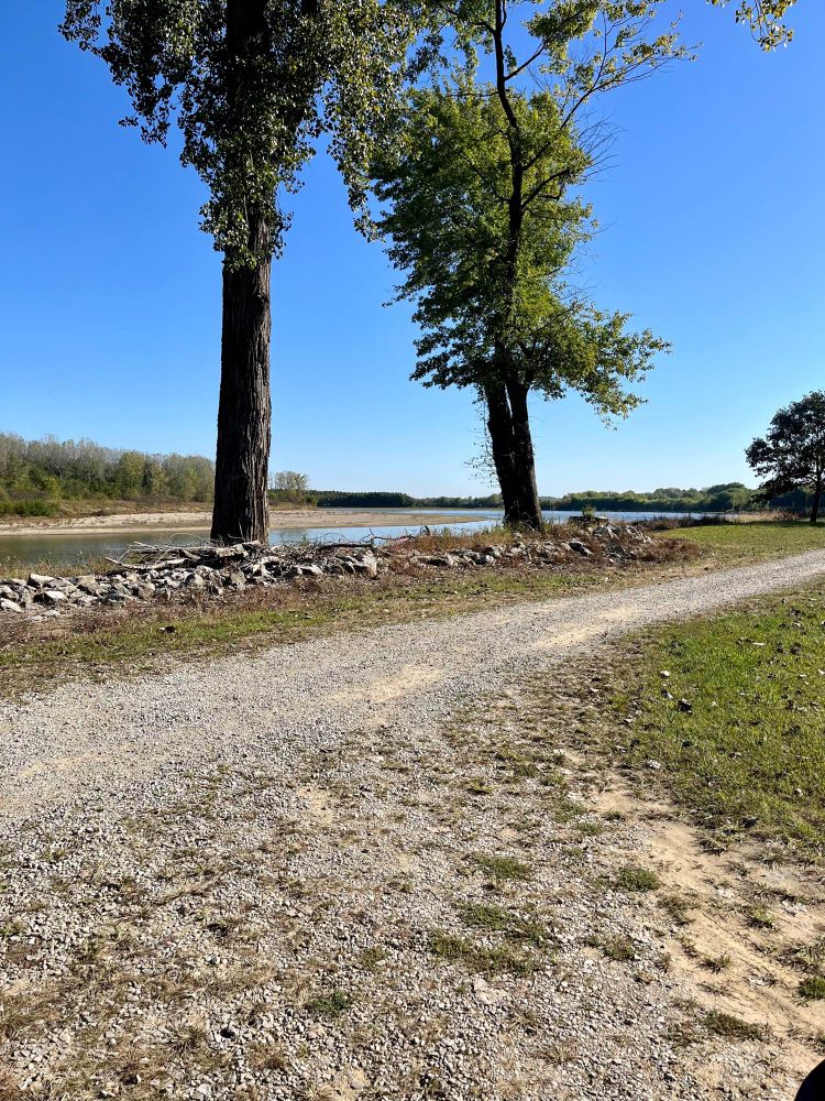 Photo of a gravel trail along a river bank.