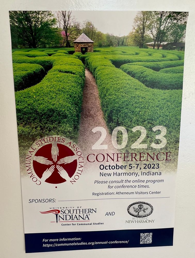 Conference poster showing a photograph of a labyrinth with green hedges and a round brick building in the center. The text on the poster says “Communal Studies Association 2023 Conference October 5-7, 2023 New Harmony, Indiana.” The logos for the sponsors, University of Southern Indiana and Historic New Harmony, are shown at the bottom.