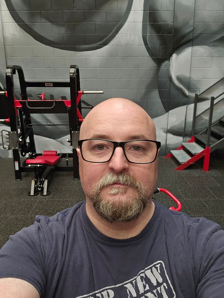 Balding middle aged man in a gym, James Mccloy 