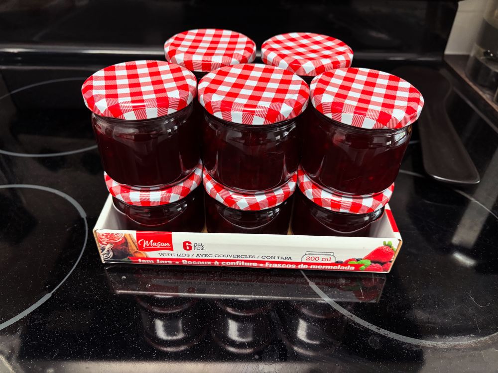 Jars of cherry jelly stacked 2 high