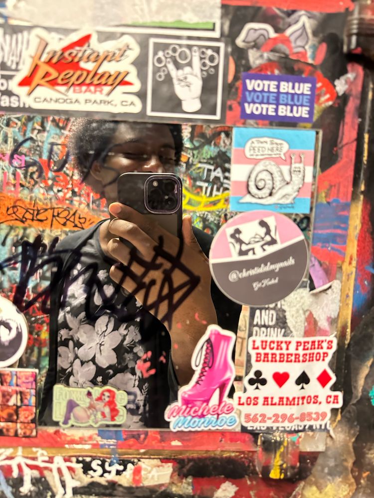 bathroom selfie featuring prism at double down in las vegas. it’s the only mirror here. there are a lot of band stickers around the small vanity mirror in the womens room 😘
