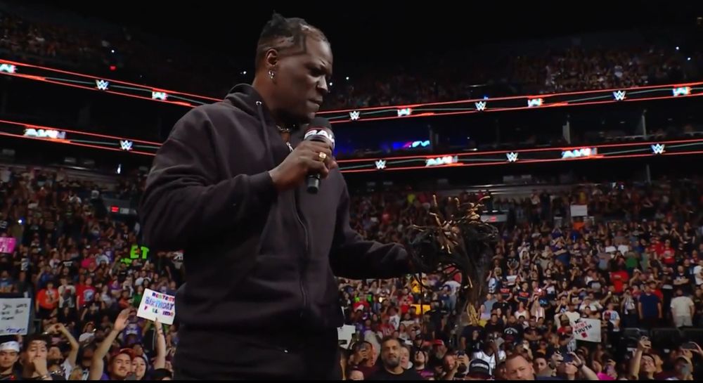 Ron Killings stands on top of the announce desk after cutting off his dreadlocks on the June 9 edition of WWE Monday Night Raw. 