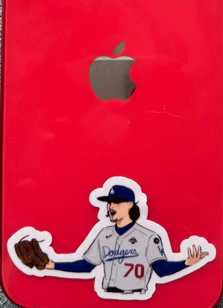 My personal phone, a red iPhone, with a Justin Wrobleski sticker on the back in the “Fuck you motherfucker” pose from game seven of the World Series where he politely invited Andrés Gimenez to join him in conversation. 